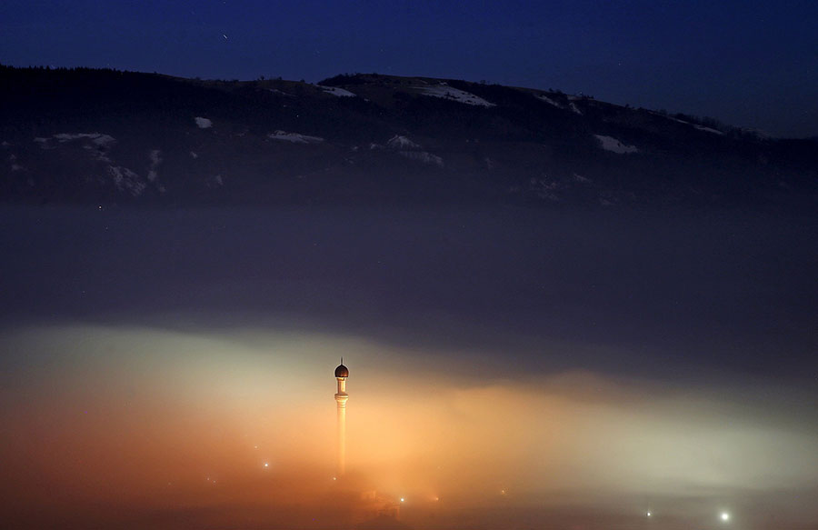 Ponijeri, Bosnia and Herzegovina A minaret rises above the smog Photograph: Dado Ruvic/Reuters